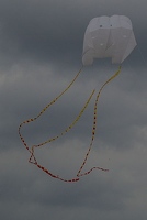 Spooky ghost kite on gray clouds