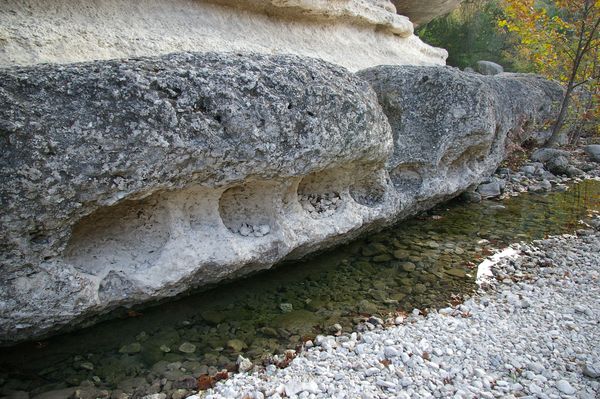 Round holes in side of rock
